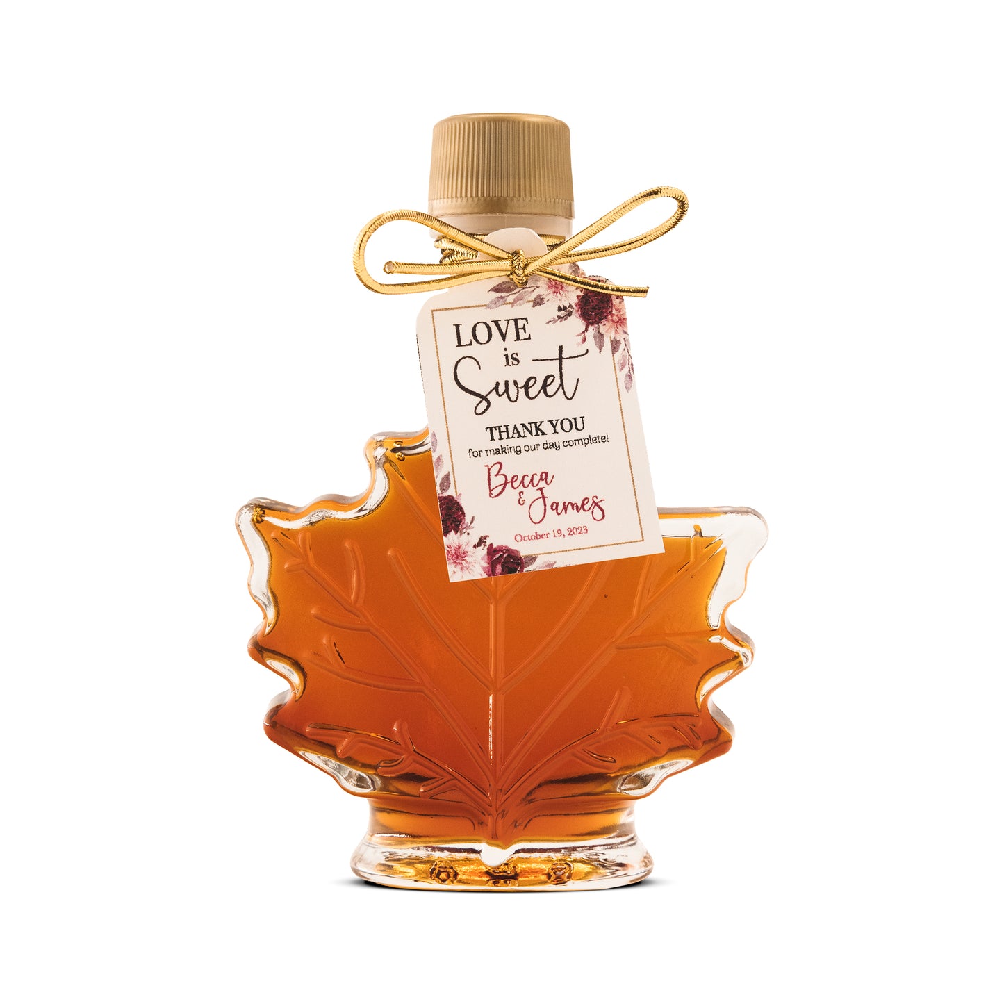 A 1.7 oz glass leaf bottle of maple syrup wedding favor from Ben's Sugar Shack.