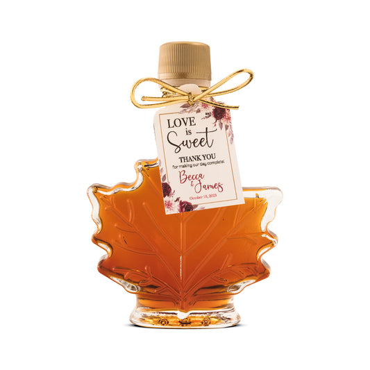 A 1.7 oz glass leaf bottle of maple syrup wedding favor from Ben's Sugar Shack.