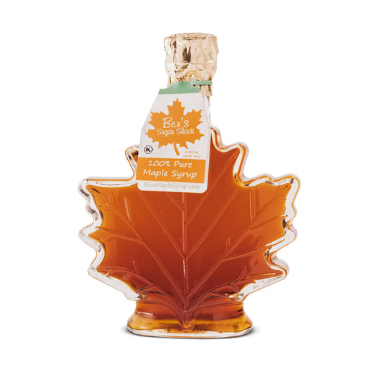 A 16.9 oz. glass leaf bottle of 100% pure maple syrup from Ben's Sugar Shack.